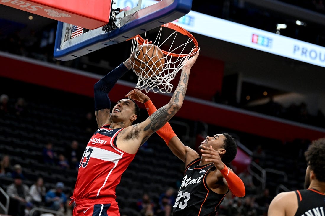 Jan 27, 2024; Detroit, Michigan, USA; Washington Wizards forward Kyle Kuzma (33) dunks the ball over Detroit Pistons guard Jaden Ivey (23) in the fourth quarter at Little Caesars Arena. Mandatory Credit: Lon Horwedel-USA TODAY Sports