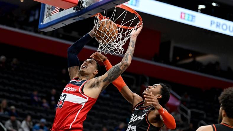 Jan 27, 2024; Detroit, Michigan, USA; Washington Wizards forward Kyle Kuzma (33) dunks the ball over Detroit Pistons guard Jaden Ivey (23) in the fourth quarter at Little Caesars Arena. Mandatory Credit: Lon Horwedel-USA TODAY Sports