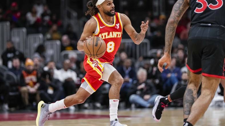 Jan 28, 2024; Atlanta, Georgia, USA; Atlanta Hawks guard Patty Mills (8) brings the ball up the court against the Toronto Raptors during the first half at State Farm Arena. Mandatory Credit: Dale Zanine-USA TODAY Sports