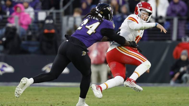 Jan 28, 2024; Baltimore, Maryland, USA; Kansas City Chiefs quarterback Patrick Mahomes (15) is knocked down after passing the ball by Baltimore Ravens linebacker Jadeveon Clowney (24) in the AFC Championship football game at M&T Bank Stadium. Mandatory Credit: Geoff Burke-USA TODAY Sports