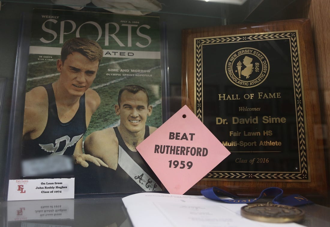 Fair Lawn, NJ -- Feb. 2, 2024 -- A July 1956 cover from Weekly Sports Illustrated features Dave Sime, at left, when he ran track for Duke University.
The trophy case and Hall of Fame Wall at Fair Lawn HS honors one of their alumni, Dave Sime. He was a star athlete at Fair-Lawn in the 1950s, passing away in 2016. He is the grandfather of San Francisco 49ers star running back Christian McCaffrey, who will be playing in the Super Bowl.