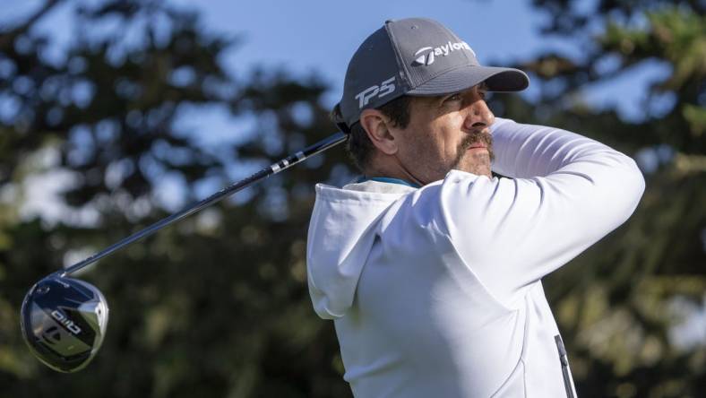 February 2, 2024; Pebble Beach, California, USA; New York Jets quarterback Aaron Rodgers hits his tee shot on the 16th hole during the second round of the AT&T Pebble Beach Pro-Am golf tournament at Pebble Beach Golf Links. Mandatory Credit: Kyle Terada-USA TODAY Sports