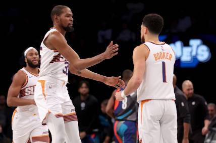Jan 31, 2024; Brooklyn, New York, USA; Phoenix Suns forward Kevin Durant (35) high fives guard Devin Booker (1) during the third quarter against the Brooklyn Nets at Barclays Center. Mandatory Credit: Brad Penner-USA TODAY Sports