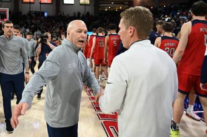 Feb 3, 2024; Spokane, Washington, USA; St. Mary's Gaels head coach Randy Bennett meets with Gonzaga Bulldogs head coach Mark Few after a game at McCarthey Athletic Center. St. Mary's Gaels won 64-62. Mandatory Credit: James Snook-USA TODAY Sports