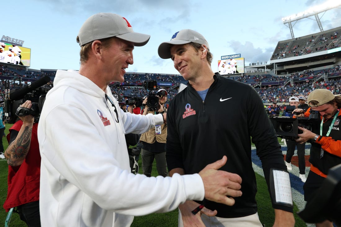 Feb 4, 2024; Orlando, FL, USA; NFC coach Eli Manning and AFC coach Peyton Manning react after the 2024 Pro Bowl at Camping World Stadium. Mandatory Credit: Nathan Ray Seebeck-USA TODAY Sports