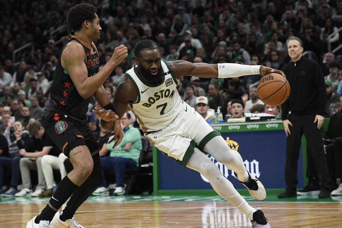 Feb 9, 2024; Boston, Massachusetts, USA; Boston Celtics guard Jaylen Brown (7) controls the ball while Washington Wizards guard Jordan Poole (13) defends during the second half at TD Garden. Mandatory Credit: Bob DeChiara-USA TODAY Sports