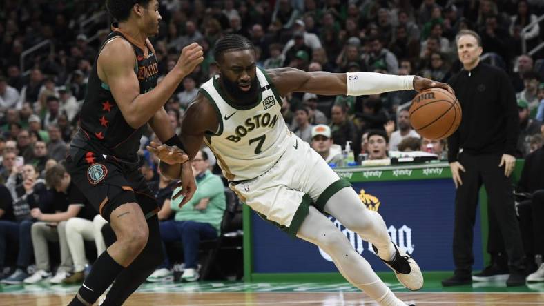 Feb 9, 2024; Boston, Massachusetts, USA; Boston Celtics guard Jaylen Brown (7) controls the ball while Washington Wizards guard Jordan Poole (13) defends during the second half at TD Garden. Mandatory Credit: Bob DeChiara-USA TODAY Sports