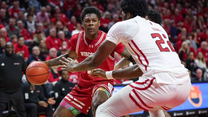 Feb 10, 2024; Piscataway, New Jersey, USA; Wisconsin Badgers guard AJ Storr (left) dribbles the ball against Rutgers Scarlet Knights center Emmanuel Ogbole (22) during the first half at Jersey Mike's Arena. Mandatory Credit: Vincent Carchietta-USA TODAY Sports