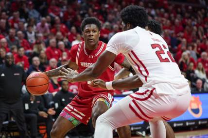 Feb 10, 2024; Piscataway, New Jersey, USA; Wisconsin Badgers guard AJ Storr (left) dribbles the ball against Rutgers Scarlet Knights center Emmanuel Ogbole (22) during the first half at Jersey Mike's Arena. Mandatory Credit: Vincent Carchietta-USA TODAY Sports