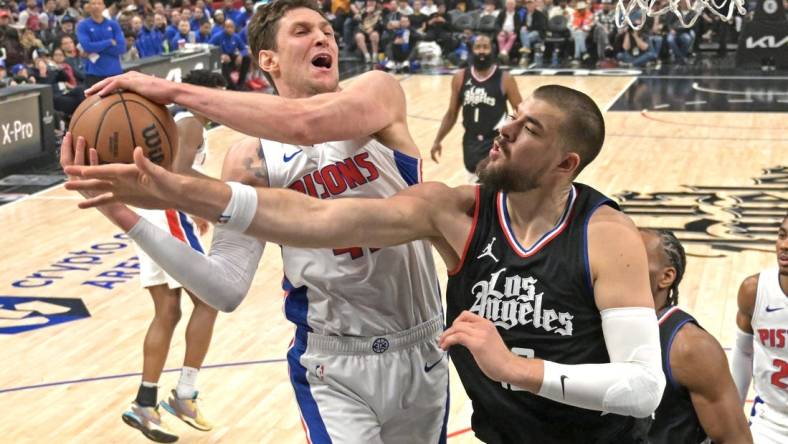 Feb 10, 2024; Los Angeles, California, USA;  Detroit Pistons center Mike Muscala (41) reaches in front of Los Angeles Clippers center Ivica Zubac (40) for a rebound in the first half at Crypto.com Arena. Mandatory Credit: Jayne Kamin-Oncea-USA TODAY Sports