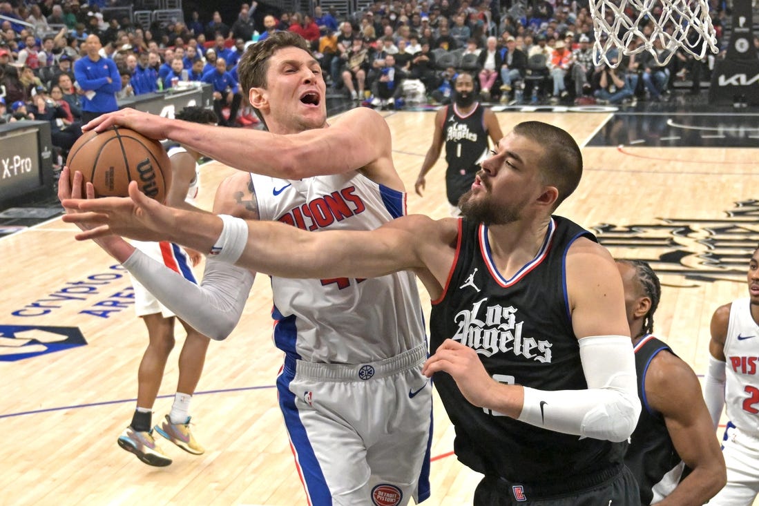 Feb 10, 2024; Los Angeles, California, USA;  Detroit Pistons center Mike Muscala (41) reaches in front of Los Angeles Clippers center Ivica Zubac (40) for a rebound in the first half at Crypto.com Arena. Mandatory Credit: Jayne Kamin-Oncea-USA TODAY Sports