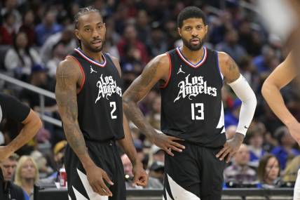 Feb 10, 2024; Los Angeles, California, USA;   Los Angeles Clippers forward Kawhi Leonard (2) and forward Paul George (13) look on in the second half against the Detroit Pistons at Crypto.com Arena. Mandatory Credit: Jayne Kamin-Oncea-USA TODAY Sports