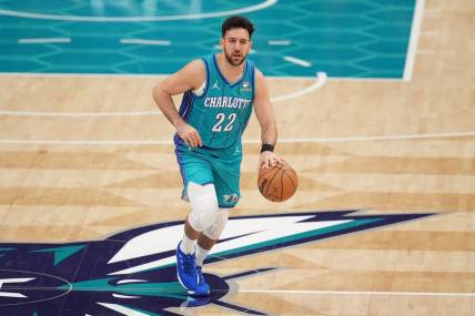 Feb 10, 2024; Charlotte, North Carolina, USA; Charlotte Hornets guard Vasilije Micic (22) brings the ball up court during the second quarter against the Memphis Grizzlies at Spectrum Center. Mandatory Credit: Jim Dedmon-USA TODAY Sports