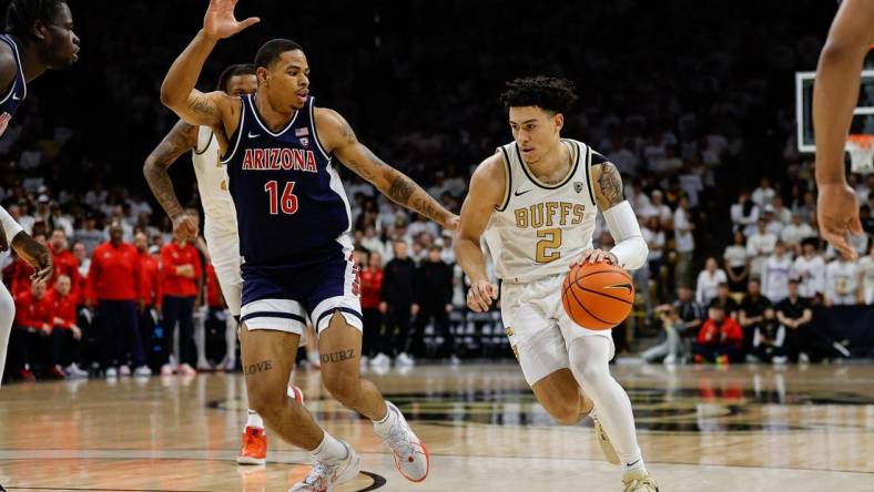 Feb 10, 2024; Boulder, Colorado, USA; Colorado Buffaloes guard KJ Simpson (2) controls the ball against Arizona Wildcats forward Keshad Johnson (16) in the second half at CU Events Center. Mandatory Credit: Isaiah J. Downing-USA TODAY Sports