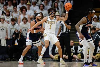 Feb 10, 2024; Boulder, Colorado, USA; Colorado Buffaloes guard J'Vonne Hadley (1) controls the ball against Arizona Wildcats guard Kylan Boswell (4) in the first half at CU Events Center. Mandatory Credit: Isaiah J. Downing-USA TODAY Sports