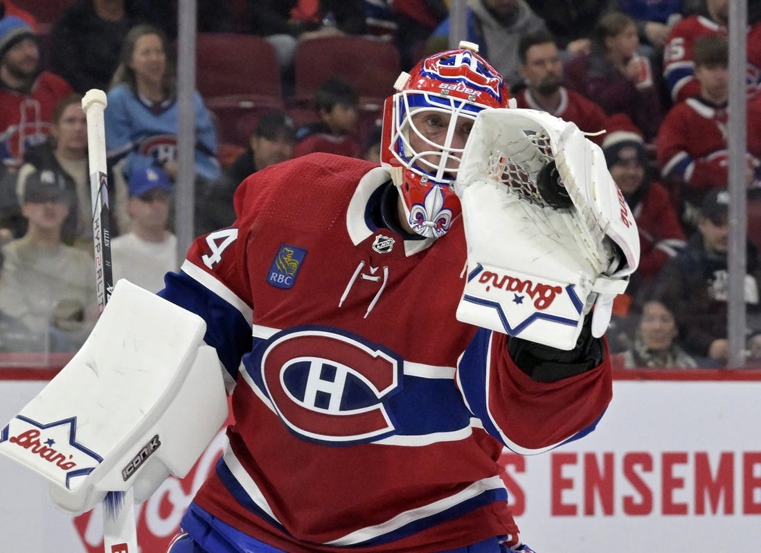 Feb 11, 2024; Montreal, Quebec, CAN; Montreal Canadiens goalie Jake Allen (34) makes a glove save during the first period of the game against the St.Louis Blues at the Bell Centre. Mandatory Credit: Eric Bolte-USA TODAY Sports