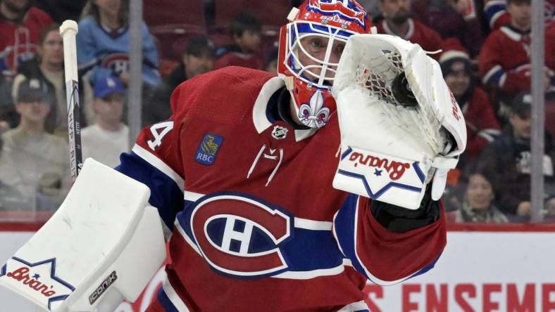 Feb 11, 2024; Montreal, Quebec, CAN; Montreal Canadiens goalie Jake Allen (34) makes a glove save during the first period of the game against the St.Louis Blues at the Bell Centre. Mandatory Credit: Eric Bolte-USA TODAY Sports