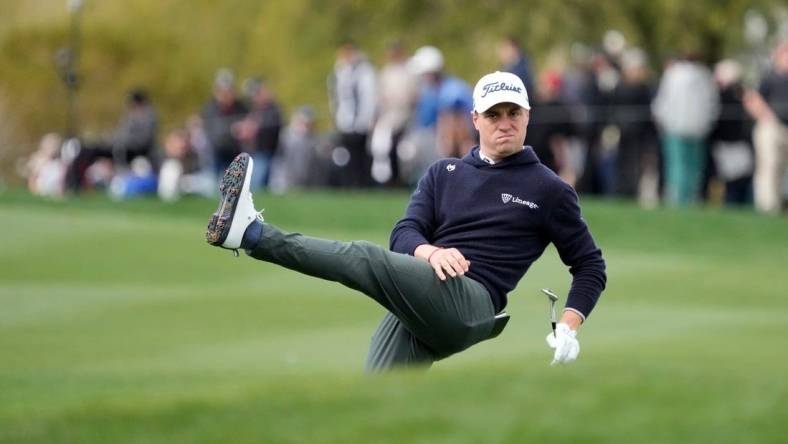 Justin Thomas reacts after his pitch onto the 15th green during round 2 of the WM Phoenix Open at TPC Scottsdale on Feb. 8, 2024.