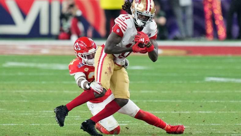 Feb 11, 2024; Paradise, Nevada, USA; Kansas City Chiefs safety Mike Edwards (21) tackles San Francisco 49ers wide receiver Brandon Aiyuk (11) during overtime of Super Bowl LVIII at Allegiant Stadium. Mandatory Credit: Kyle Terada-USA TODAY Sports