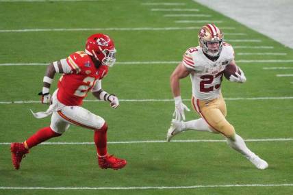 Feb 11, 2024; Paradise, Nevada, USA; San Francisco 49ers running back Christian McCaffrey (23) runs with the ball against Kansas City Chiefs safety Mike Edwards (21) during overtime of Super Bowl LVIII at Allegiant Stadium. Mandatory Credit: Joe Camporeale-USA TODAY Sports