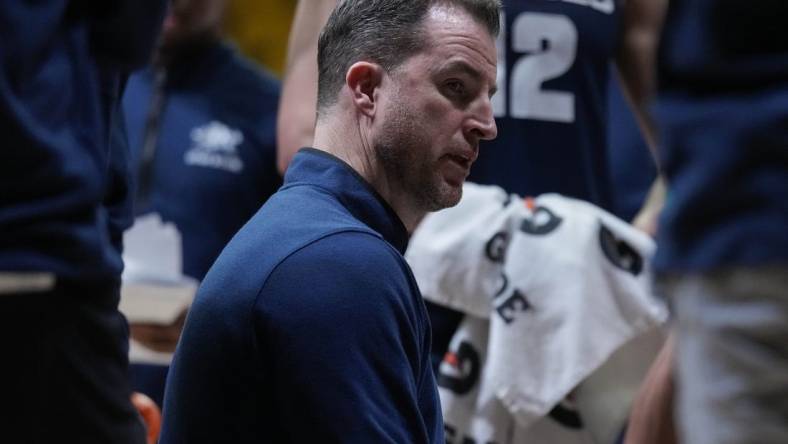 Feb 14, 2024; Laramie, Wyoming, USA; Utah State Aggies head coach Danny Sprinkle draws up a play against the Wyoming Cowboys during the second half at Arena-Auditorium. Mandatory Credit: Troy Babbitt-USA TODAY Sports