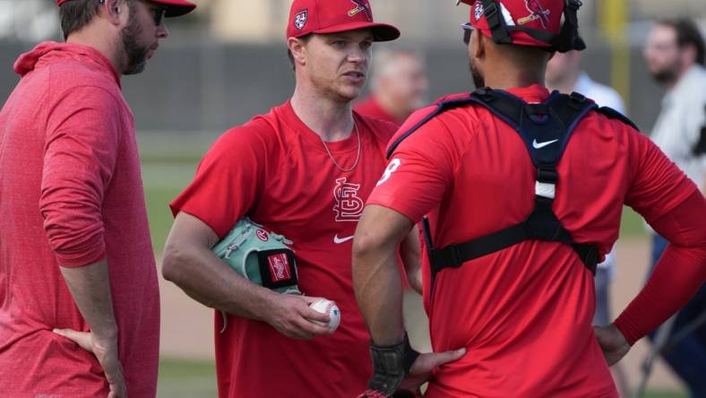 Feb 15, 2024; Jupiter, FL, USA;  St. Louis Cardinals starting pitcher Sonny Gray, center, talks with catcher Ivan Herrera (48) during workouts at spring training. Mandatory Credit: Jim Rassol-USA TODAY Sports