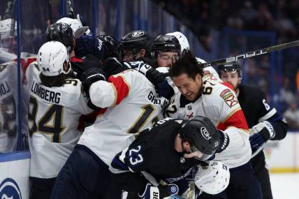 Feb 17, 2024; Tampa, Florida, USA;  the Tampa Bay Lightning and Florida Panthers scuffle on the boards in the third period at Amalie Arena. Mandatory Credit: Nathan Ray Seebeck-USA TODAY Sports