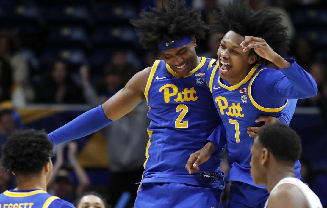 Feb 17, 2024; Pittsburgh, Pennsylvania, USA;  Pittsburgh Panthers forward Blake Hinson (2) and guard Carlton Carrington (7) celebrate after Hinson hit a three point basket to break the forty point mark against the Louisville Cardinals during the second half at the Petersen Events Center. Pittsburgh won 86-59. Mandatory Credit: Charles LeClaire-USA TODAY Sports