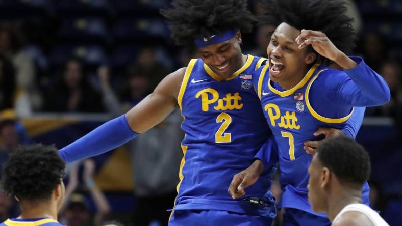 Feb 17, 2024; Pittsburgh, Pennsylvania, USA;  Pittsburgh Panthers forward Blake Hinson (2) and guard Carlton Carrington (7) celebrate after Hinson hit a three point basket to break the forty point mark against the Louisville Cardinals during the second half at the Petersen Events Center. Pittsburgh won 86-59. Mandatory Credit: Charles LeClaire-USA TODAY Sports