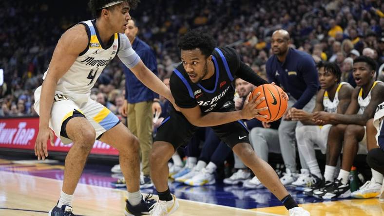 Feb 21, 2024; Milwaukee, Wisconsin, USA;  DePaul Blue Demons guard Chico Carter Jr. (2) holds the ball away from Marquette Golden Eagles guard Stevie Mitchell (4) during the first half at Fiserv Forum. Mandatory Credit: Jeff Hanisch-USA TODAY Sports