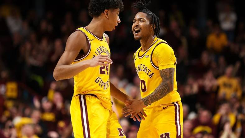 Feb 22, 2024; Minneapolis, Minnesota, USA; Minnesota Golden Gophers guard Elijah Hawkins (0) celebrates after guard Cam Christie's (24) three-point basket against the Ohio State Buckeyes during the second half at Williams Arena. Mandatory Credit: Matt Krohn-USA TODAY Sports