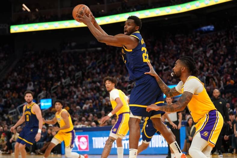 Feb 22, 2024; San Francisco, California, USA; Golden State Warriors forward Andrew Wiggins (22) holds onto a pass against the Los Angeles Lakers in the fourth quarter at the Chase Center. Mandatory Credit: Cary Edmondson-USA TODAY Sports