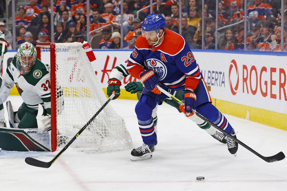 Feb 23, 2024; Edmonton, Alberta, CAN; Edmonton Oilers forward Leon Draisaitl (29) looks to make a pass in front of Minnesota Wild defensemen Dakota Mermis (6) during the first period at Rogers Place. Mandatory Credit: Perry Nelson-USA TODAY Sports