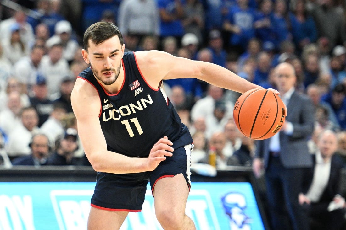 Feb 20, 2024; Omaha, Nebraska, USA;  Connecticut Huskies forward Alex Karaban (11) dribbles against the Creighton Bluejays in the first half at CHI Health Center Omaha. Mandatory Credit: Steven Branscombe-USA TODAY Sports