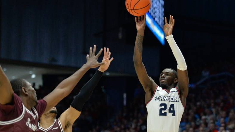 Feb 17, 2024; Dayton, Ohio, USA;  Dayton Flyers guard Kobe Elvis (24) shoots the ball against Fordham guard Antrell Charlton (24) during the game at University of Dayton Arena. Mandatory Credit: Matt Lunsford-USA TODAY Sports