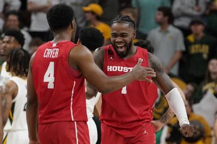 Feb 24, 2024; Waco, Texas, USA; Houston Cougars guard L.J. Cryer (4) and guard Jamal Shead (1) react in the closing moments of overtime against the Baylor Bears at Paul and Alejandra Foster Pavilion. Mandatory Credit: Raymond Carlin III-USA TODAY Sports