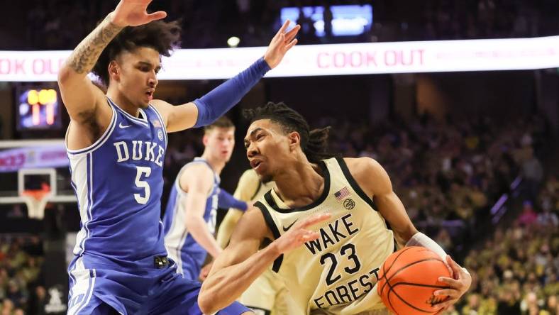 Feb 24, 2024; Winston-Salem, North Carolina, USA;  Wake Forest Demon Deacons guard Hunter Sallis (23) fights for position against Duke Blue Devils guard Tyrese Proctor (5) during the first half at Lawrence Joel Veterans Memorial Coliseum. Mandatory Credit: Cory Knowlton-USA TODAY Sports