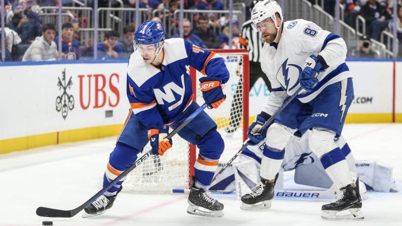 Feb 24, 2024; Elmont, New York, USA;  New York Islanders center Jean-Gabriel Pageau (44) and Tampa Bay Lightning defenseman Erik Cernak (81) battle for control of the puck in the second period at UBS Arena. Mandatory Credit: Wendell Cruz-USA TODAY Sports