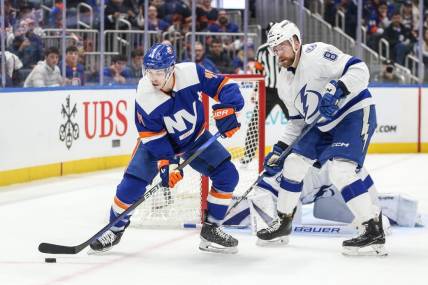 Feb 24, 2024; Elmont, New York, USA;  New York Islanders center Jean-Gabriel Pageau (44) and Tampa Bay Lightning defenseman Erik Cernak (81) battle for control of the puck in the second period at UBS Arena. Mandatory Credit: Wendell Cruz-USA TODAY Sports