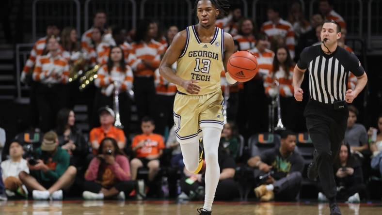 Feb 24, 2024; Coral Gables, Florida, USA; Georgia Tech Yellow Jackets guard Miles Kelly (13) dribbles the basketball against the Miami Hurricanes during the first half at Watsco Center. Mandatory Credit: Sam Navarro-USA TODAY Sports