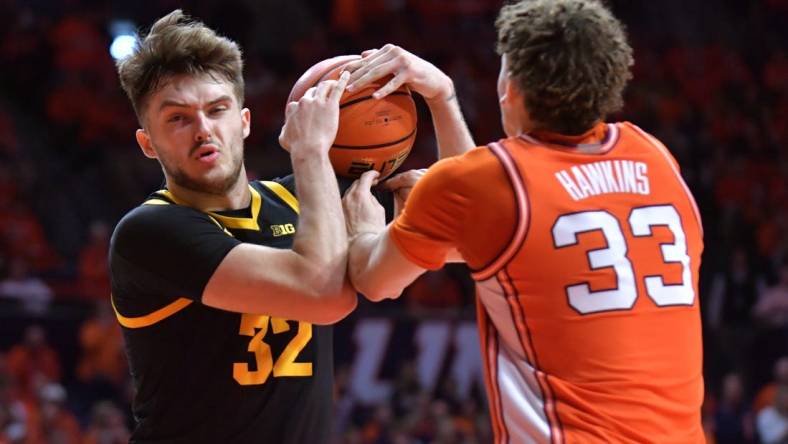 Illinois Fighting Illini forward Coleman Hawkins (33) and Iowa Hawkeyes forward Owen Freeman (32) wrestle for a rebound during the second half at State Farm Center. Mandatory Credit: Ron Johnson-USA TODAY Sports