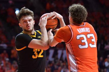 Illinois Fighting Illini forward Coleman Hawkins (33) and Iowa Hawkeyes forward Owen Freeman (32) wrestle for a rebound during the second half at State Farm Center. Mandatory Credit: Ron Johnson-USA TODAY Sports