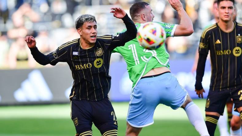 Feb 24, 2024; Los Angeles, California, USA; LAFC defender Omar Campos (2) plays for the ball against Seattle Sounders FC forward Jordan Morris (13) during the first half at BMO Stadium. Mandatory Credit: Gary A. Vasquez-USA TODAY Sports