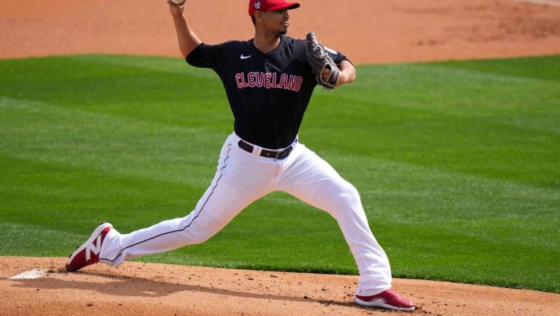 Cleveland Guardians pitcher Carlos Carrasco delivers a pitch in the first inning during a MLB spring training baseball game against the Cincinnati Reds, Saturday, Feb. 24, 2024, at Goodyear Ballpark in Goodyear, Ariz.