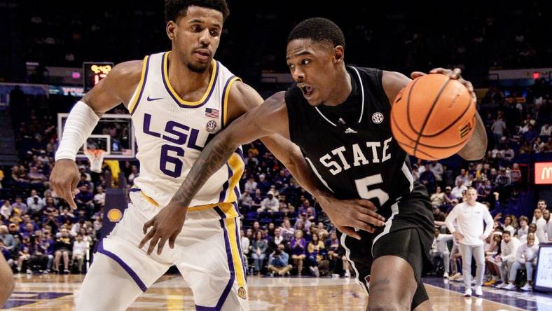 Feb 24, 2024; Baton Rouge, Louisiana, USA; Mississippi State Bulldogs guard Shawn Jones Jr. (5) drives to the basket against LSU Tigers guard Jordan Wright (6) during the second half at Pete Maravich Assembly Center. Mandatory Credit: Stephen Lew-USA TODAY Sports