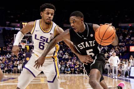 Feb 24, 2024; Baton Rouge, Louisiana, USA; Mississippi State Bulldogs guard Shawn Jones Jr. (5) drives to the basket against LSU Tigers guard Jordan Wright (6) during the second half at Pete Maravich Assembly Center. Mandatory Credit: Stephen Lew-USA TODAY Sports