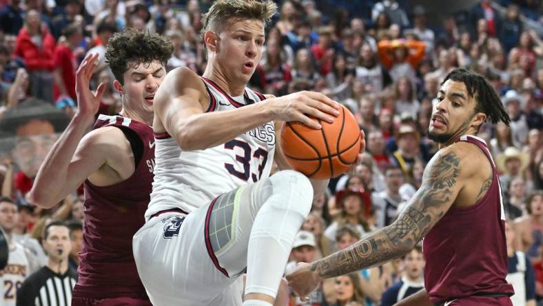 Feb 24, 2024; Spokane, Washington, USA; Gonzaga Bulldogs forward Ben Gregg (33) rebounds the ball against Santa Clara Broncos forward Johnny O'Neil (14) in the second half at McCarthey Athletic Center. Gonzaga Bulldogs won 94-81. Mandatory Credit: James Snook-USA TODAY Sports