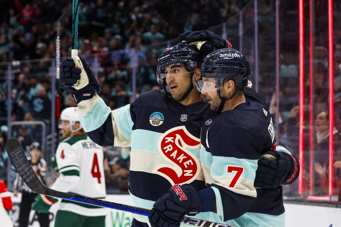 Feb 24, 2024; Seattle, Washington, USA; Seattle Kraken right wing Jordan Eberle (7) celebrates with center Matty Beniers (10) after scoring a goal against the Minnesota Wild during the third period at Climate Pledge Arena. Mandatory Credit: Joe Nicholson-USA TODAY Sports