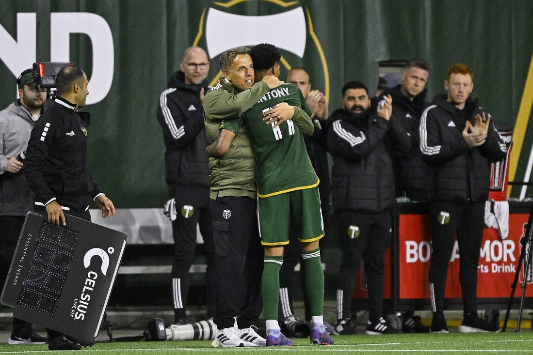 Feb 24, 2024; Portland, Oregon, USA; Portland Timbers head coach Phil Neville hugs forward Antony (11) during the second half against the Colorado Rapids at Providence Park. Mandatory Credit: Troy Wayrynen-USA TODAY Sports