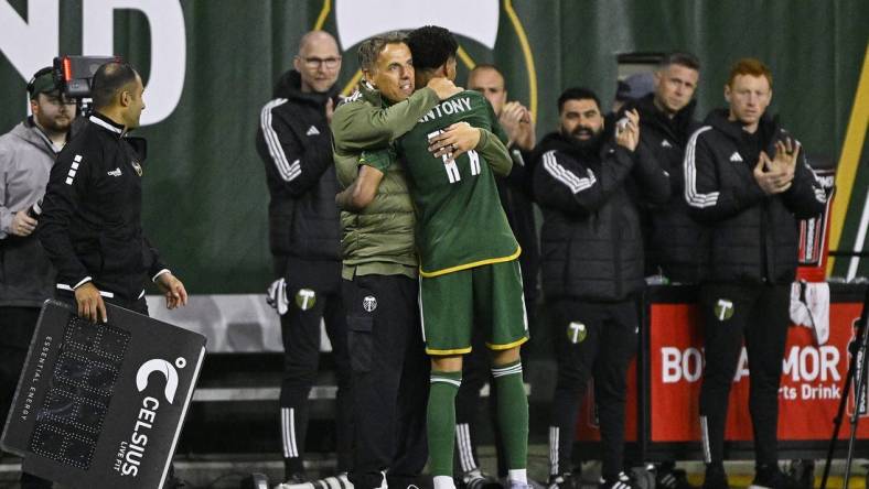 Feb 24, 2024; Portland, Oregon, USA; Portland Timbers head coach Phil Neville hugs forward Antony (11) during the second half against the Colorado Rapids at Providence Park. Mandatory Credit: Troy Wayrynen-USA TODAY Sports